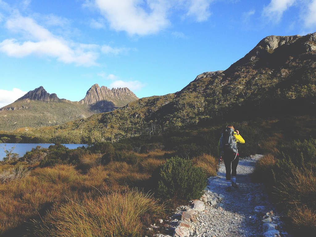 Bush Walk Trail With Hiker Near A Body Of Water Along A Mountain Range In Hobart