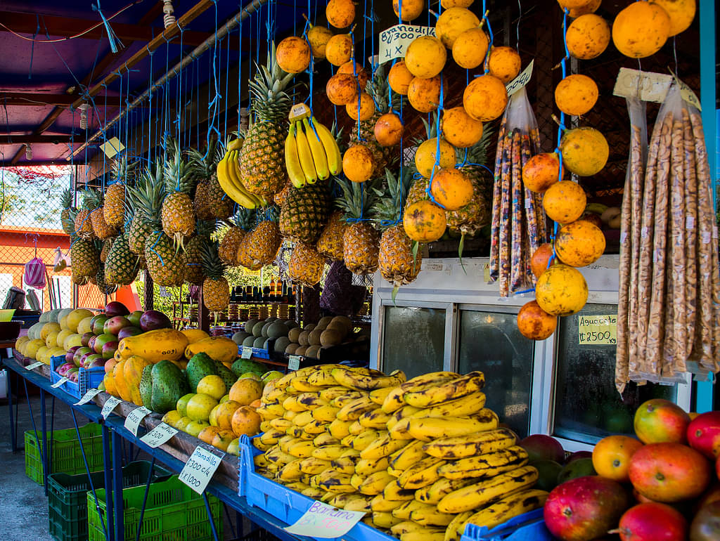 Whole Fruit Displayed In Baskets And Strung Up In Fruit Market In Costa Rica
