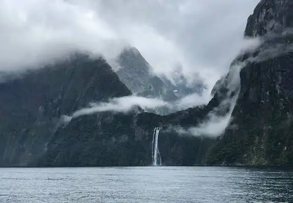 A photo of the fiord, mountains, and waterfalls at Milford Sound.