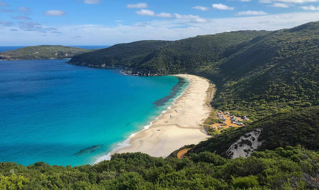 Green Valley Rolling Into Sandy Coastline Beach In Albany