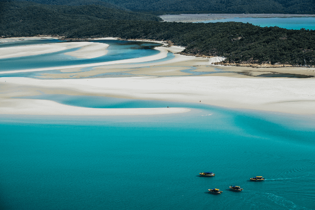 high-speed boat on the water of whitsunday islands from an aerial view
