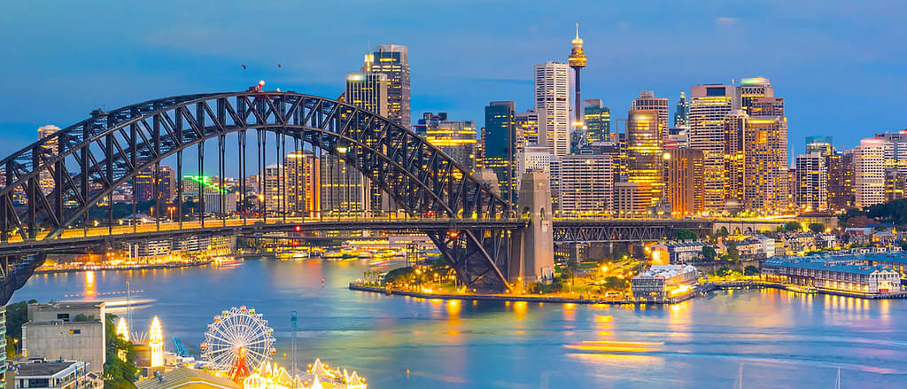 Sydney Cityscape Illuminated In The Late Afternoon With Sydney Harbour Bridge And Skyscrapers